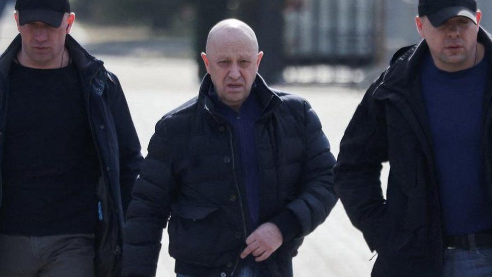 FILE PHOTO: Founder of Wagner private mercenary group Yevgeny Prigozhin walking along with two protection officers
