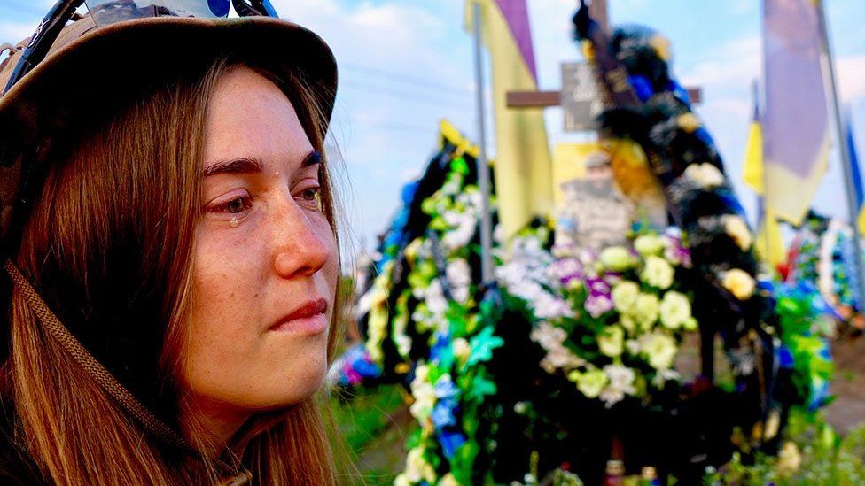Oksana cries by the graveside of her husband, who died in November