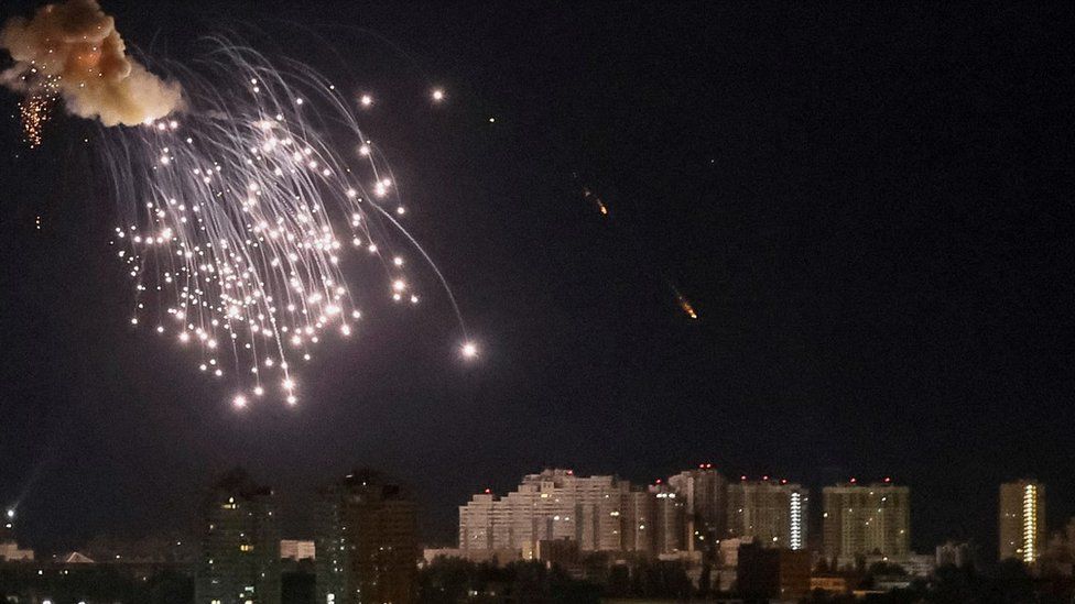 A drone exploding in the night sky over Kyiv